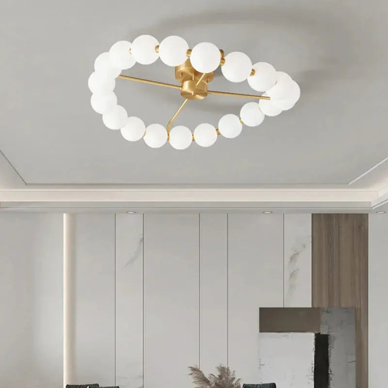 lustre à led avec anneau en cuivre et boule acrylique.